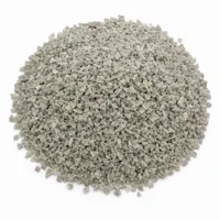 Mound of angular pale grey Aluminium Silicate 24 mesh abrasive grit on white background