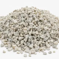 Close-up of angular off-white Aluminium Silicate 40/60 mesh abrasive grit on white background