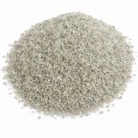 Close-up studio photo of a mound of Aluminium Silicate 40 mesh angular abrasive grit on a white background