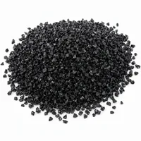 Mound of black aluminum oxide abrasive grit on white background