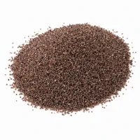 Mound of brown aluminum oxide 24 mesh abrasive grit on white background