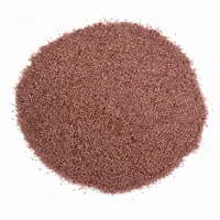 Mound of reddish-pink 24 mesh garnet sand abrasive on white background