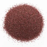 Close-up of angular dark red garnet sand 30/60 mesh abrasive grains on white background