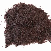 Top-down view of angular reddish-brown Garnet Sand 36 mesh abrasive particles on a white background