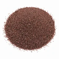 Close-up of angular pinkish-red Garnet Sand 46 mesh abrasive grains on a white background