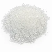 Mound of #12 mesh spherical glass bead abrasive media on white background