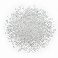 Clear spherical 16 mesh glass beads abrasive media in a mound on white background