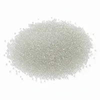 Industrial glass beads 24 mesh abrasive blasting media in a mound on white background