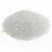Studio photograph of a mound of 40 mesh glass bead blasting media on white background