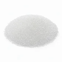 Mound of spherical translucent white glass bead abrasive media on white background