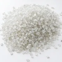 Close-up of sharp angular Plastic Abrasive 150 mesh granules on white background
