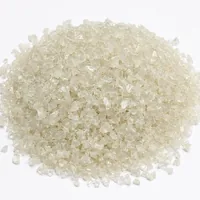 Mound of sharp angular 180 mesh plastic abrasive media on white background