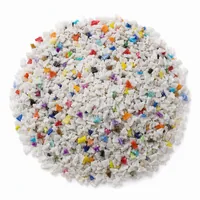 Mound of angular plastic abrasive 50 mesh grit on white background