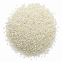 Mound of angular Urea Plastic Abrasive 60/80 mesh grit on white background