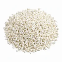 Mound of Plastic Media Type III 16 mesh angular off-white abrasive grit on white background