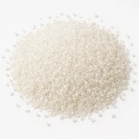 Close-up mound of Plastic Media Type V 16 mesh angular acrylic abrasive grit on white background