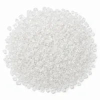 Close-up of angular white acrylic plastic abrasive media Type V 46 mesh particles on a white background
