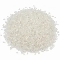 Mound of Plastic Media Type V 80 mesh angular acrylic abrasive particles on white background