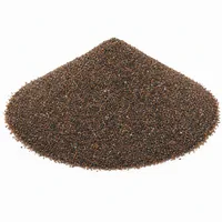 Close-up of dark reddish-brown Staurolite Sand 150 mesh abrasive media on a white background