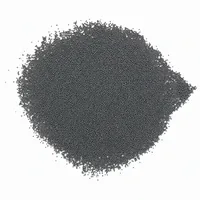 Close-up of spherical S110 high-carbon steel shot abrasive media on white background