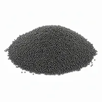 Mound of spherical steel shots abrasive media on white background